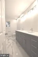 a bathroom with a sink vanity and a mirror