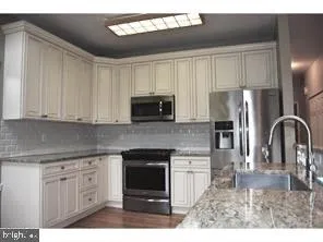 a kitchen with appliances cabinets and a sink
