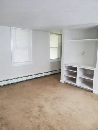 an empty room with a empty space and windows