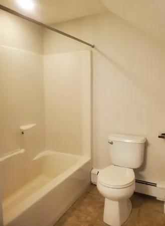 a bathroom with a toilet and a bathtub