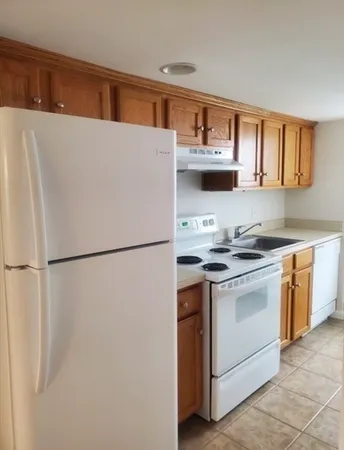 a kitchen with stainless steel appliances granite countertop white refrigerator stove a sink and dishwasher