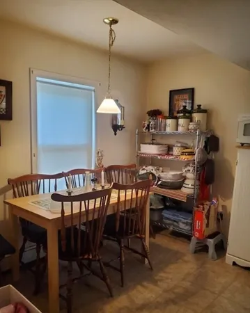 a view of a dining room with furniture and a chandelier