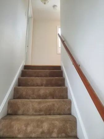 a view of staircase with white walls