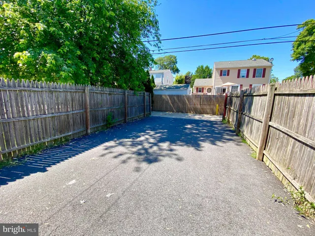 a view of a backyard with wooden fence