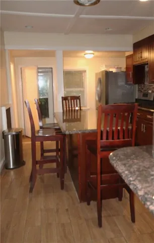 a kitchen with granite countertop lots of counter top space and furniture