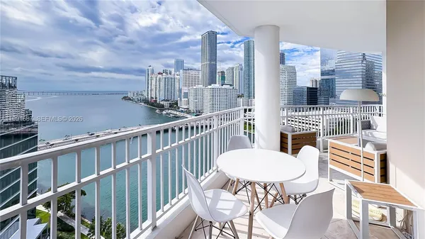 a view of a balcony with a table and chairs