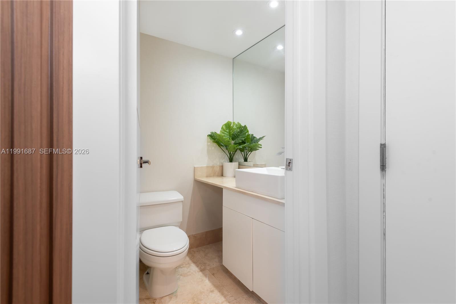 701 Brickell Key Boulevard, Unit 1912 Miami, FL 33131 - Photo 13 of 67 a bathroom with a sink a toilet and shower