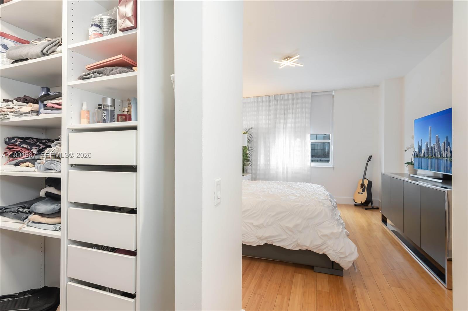 701 Brickell Key Boulevard, Unit 1912 Miami, FL 33131 - Photo 18 of 67 a bedroom with a bed and a cabinets