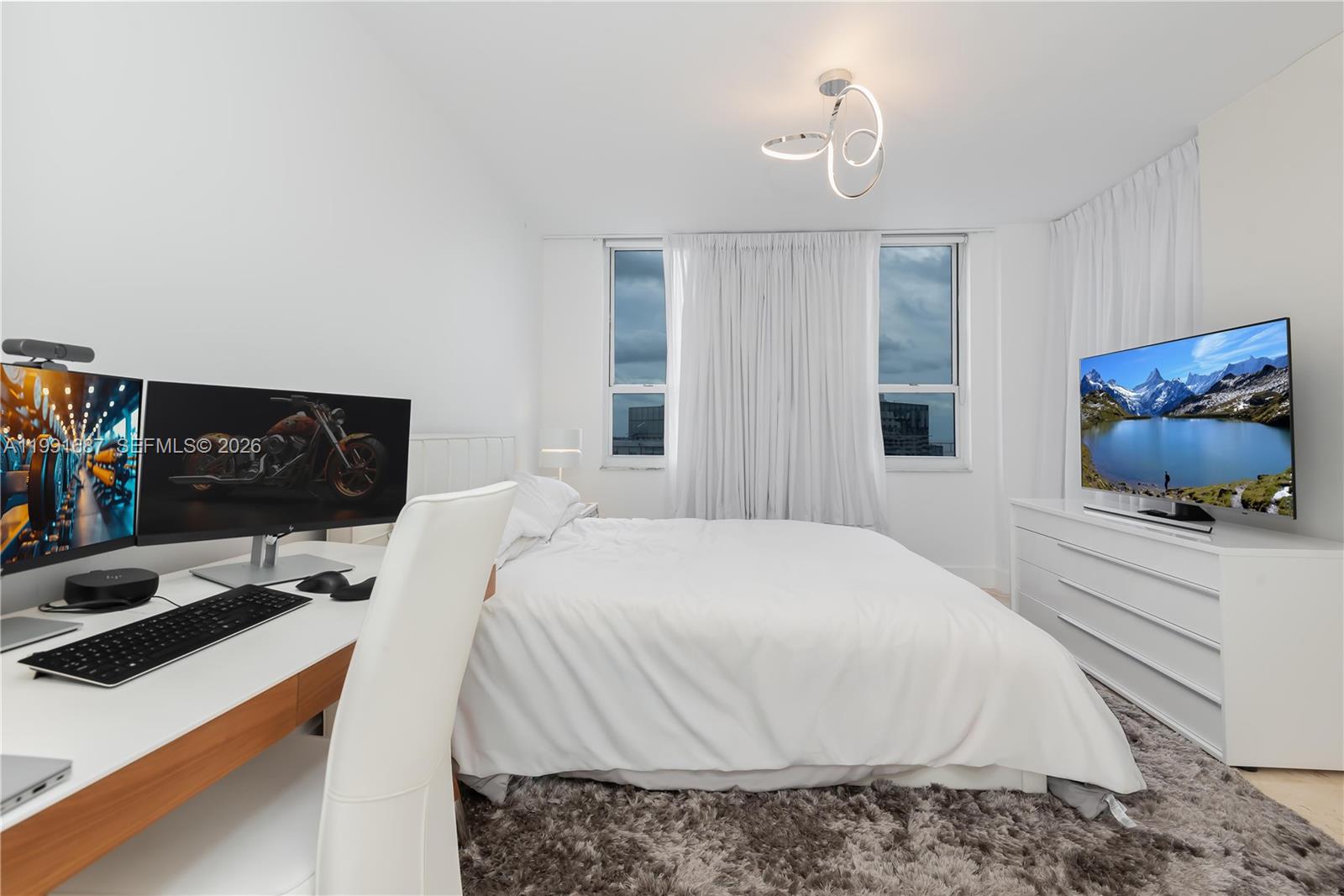 701 Brickell Key Boulevard, Unit 1912 Miami, FL 33131 - Photo 23 of 67 a bedroom with a bed and a couch