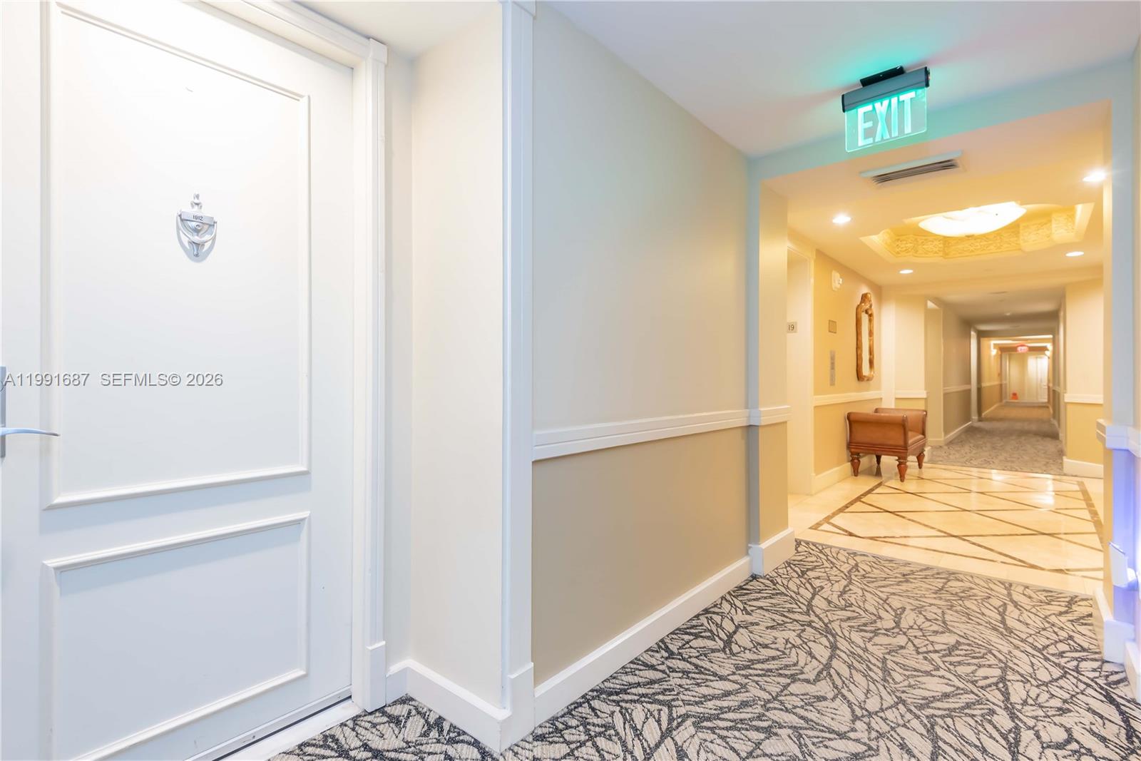 701 Brickell Key Boulevard, Unit 1912 Miami, FL 33131 - Photo 38 of 67 a view of a hallway with wooden floor and a bathroom