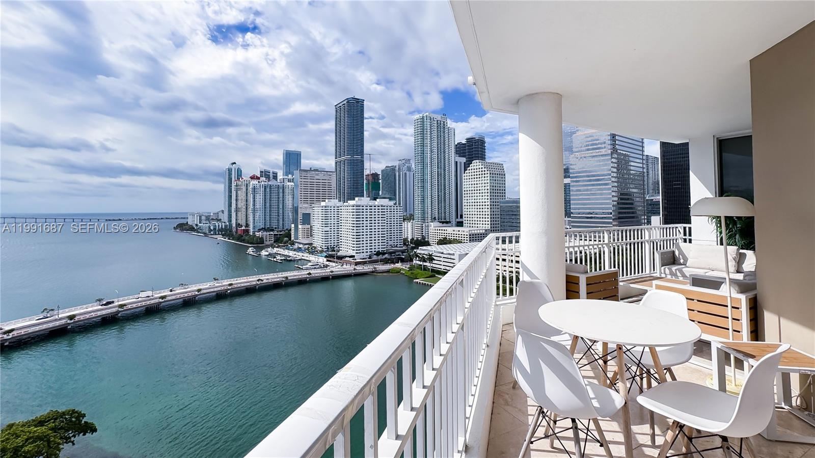 701 Brickell Key Boulevard, Unit 1912 Miami, FL 33131 - Photo 5 of 67 a balcony with table and chairs