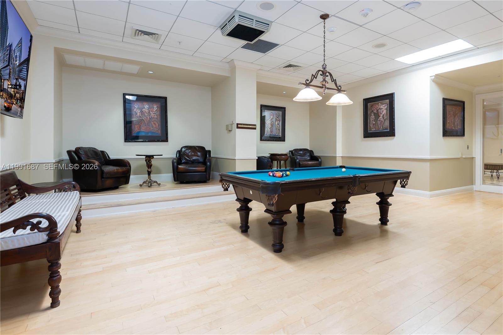 701 Brickell Key Boulevard, Unit 1912 Miami, FL 33131 - Photo 59 of 67 a living room with furniture and a chandelier