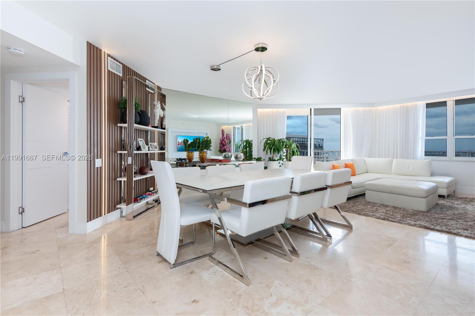 701 Brickell Key Boulevard, Unit 1912 Miami, FL 33131 - Photo 7 of 67 a living room with furniture and a large window