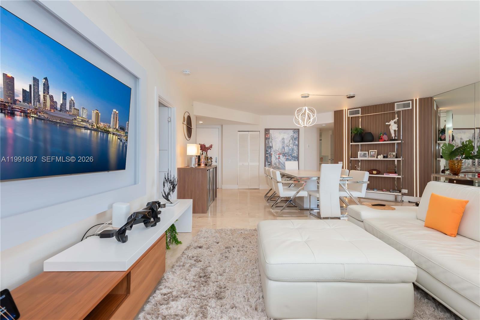 701 Brickell Key Boulevard, Unit 1912 Miami, FL 33131 - Photo 10 of 67 a living room with furniture a flat screen tv and a sink