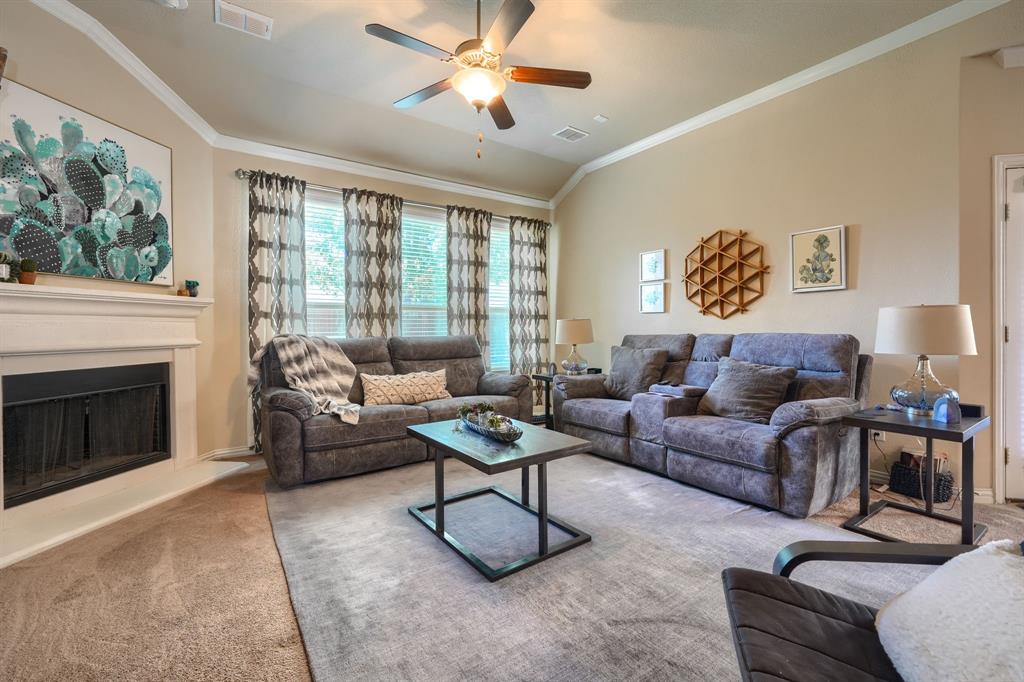 12417 Hitch Rack Way McKinney, TX 75071 - Photo 5 of 17 Carpeted living room with ceiling fan, vaulted ceiling, and crown molding