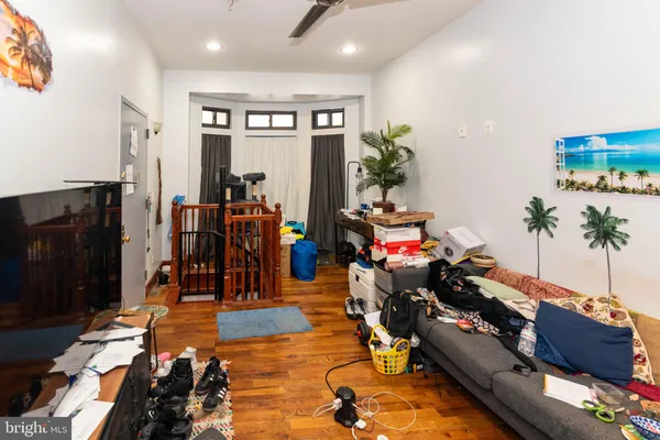 a living room with furniture gym equipment and a chandelier