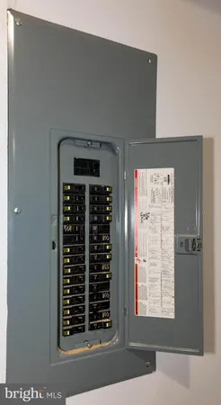 a kitchen with stainless steel appliances granite countertop a refrigerator a stove top oven a sink dishwasher and white cabinets with wooden floor