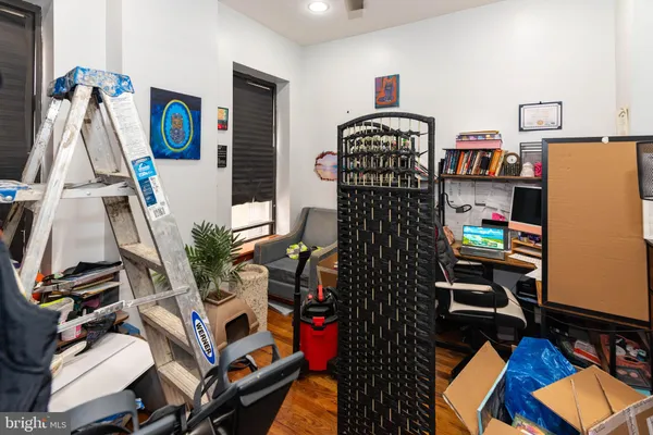 a living room with furniture closet and a flat screen tv