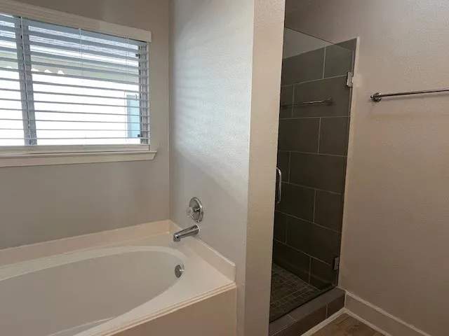 a bathroom with a bathtub and window