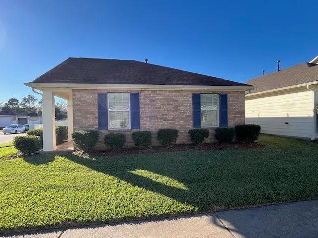a view of a house with backyard sitting area and garden