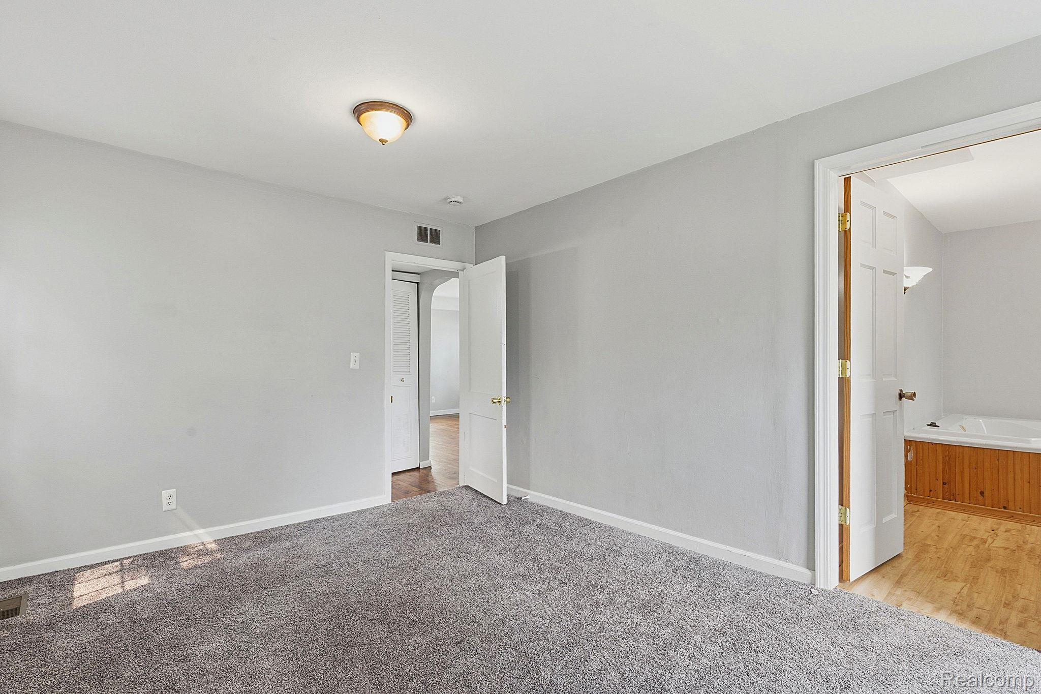5852 Beech Daly Road Taylor, MI 48180 - Photo 11 of 29 Spacious room featuring light gray walls, gray carpeting, and a flush mount ceiling light