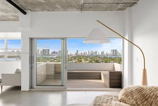 a view of living room with a floor to ceiling window and kitchen