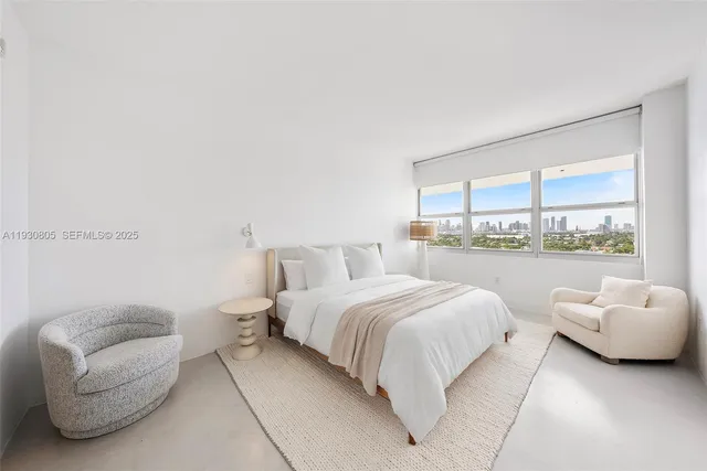 a bedroom with a bed and a large window