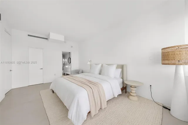 a bedroom with a bed and a night stand