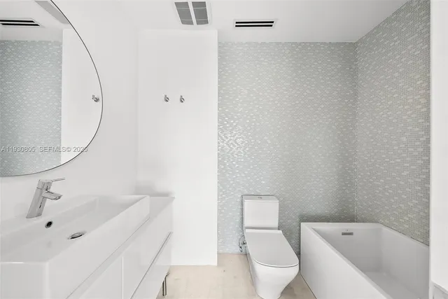 a bathroom with a bathtub and sink