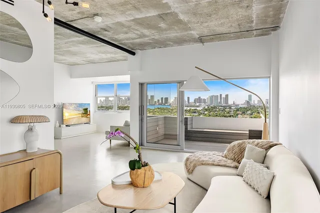 a living room with furniture flowerpot and a floor to ceiling window