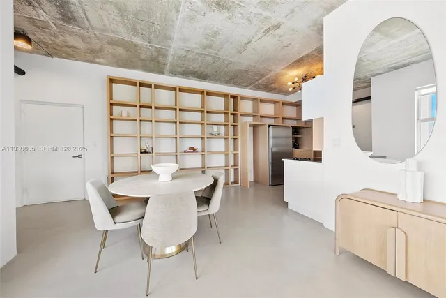 a view of a dining room with furniture and a chandelier