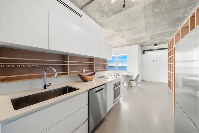 a kitchen with stainless steel appliances a sink a stove and a refrigerator