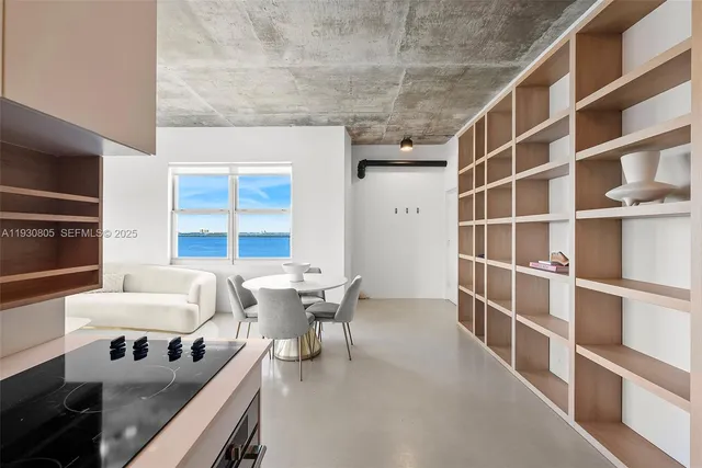 a view of a livingroom with furniture and a book shelf