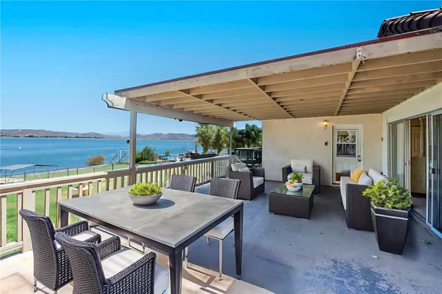 a view of a patio with a table and chairs and potted plants