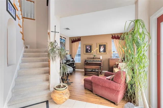 a living room with furniture and a potted plant