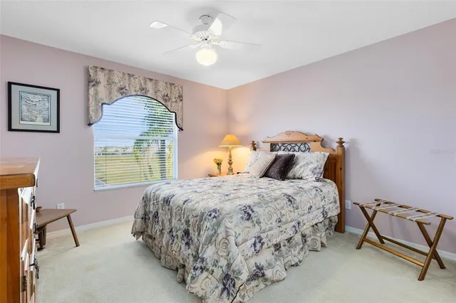 a bedroom with bed and a chandelier