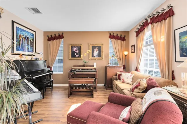 a living room with furniture a fireplace and a large window