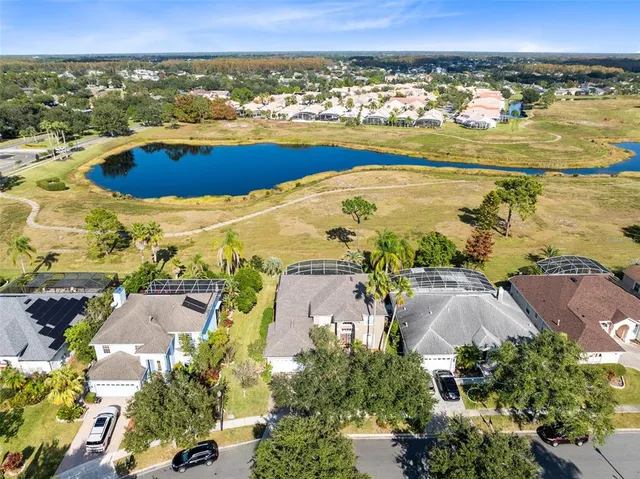 an aerial view of residential building and lake