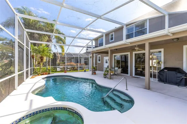 a swimming pool with outdoor seating and yard