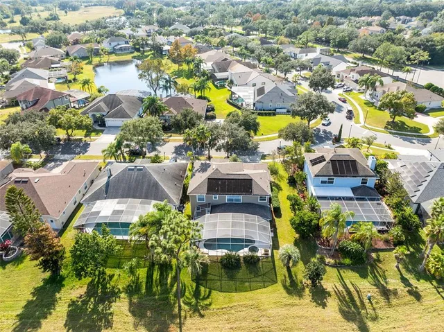 an aerial view of residential houses with yard
