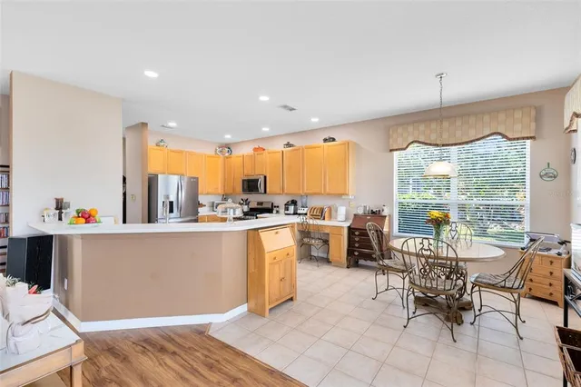 a living room with kitchen island furniture and a large window