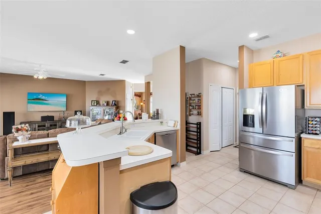 a kitchen with stainless steel appliances a refrigerator sink and stove