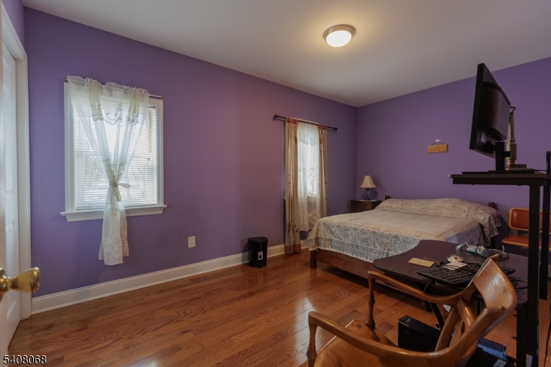 348 Cherry Street Elizabeth, NJ 07208 - Photo 18 of 28 a bedroom with a bed and wooden floor