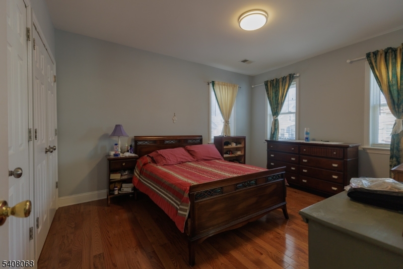 348 Cherry Street Elizabeth, NJ 07208 - Photo 19 of 28 a bedroom with a bed and wooden floor