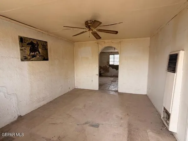 a view of a livingroom with a ceiling fan and window