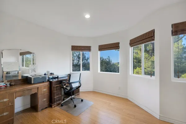 a view of a workspace with furniture and a window