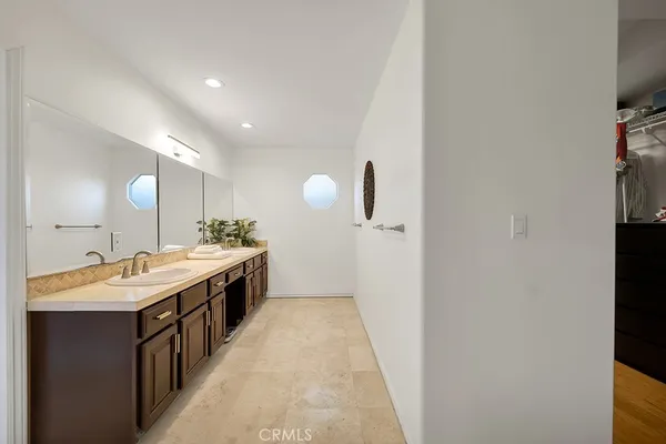 a spacious bathroom with a granite countertop sink a mirror and a toilet