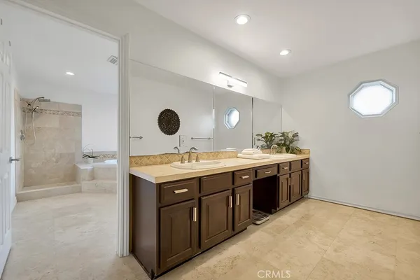 a bathroom with a sink double vanity and a shower