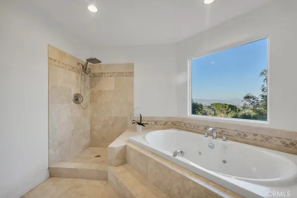 a bathroom with a bathtub and shower