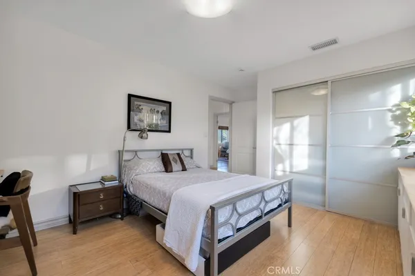 a bedroom with a bed a table and painting